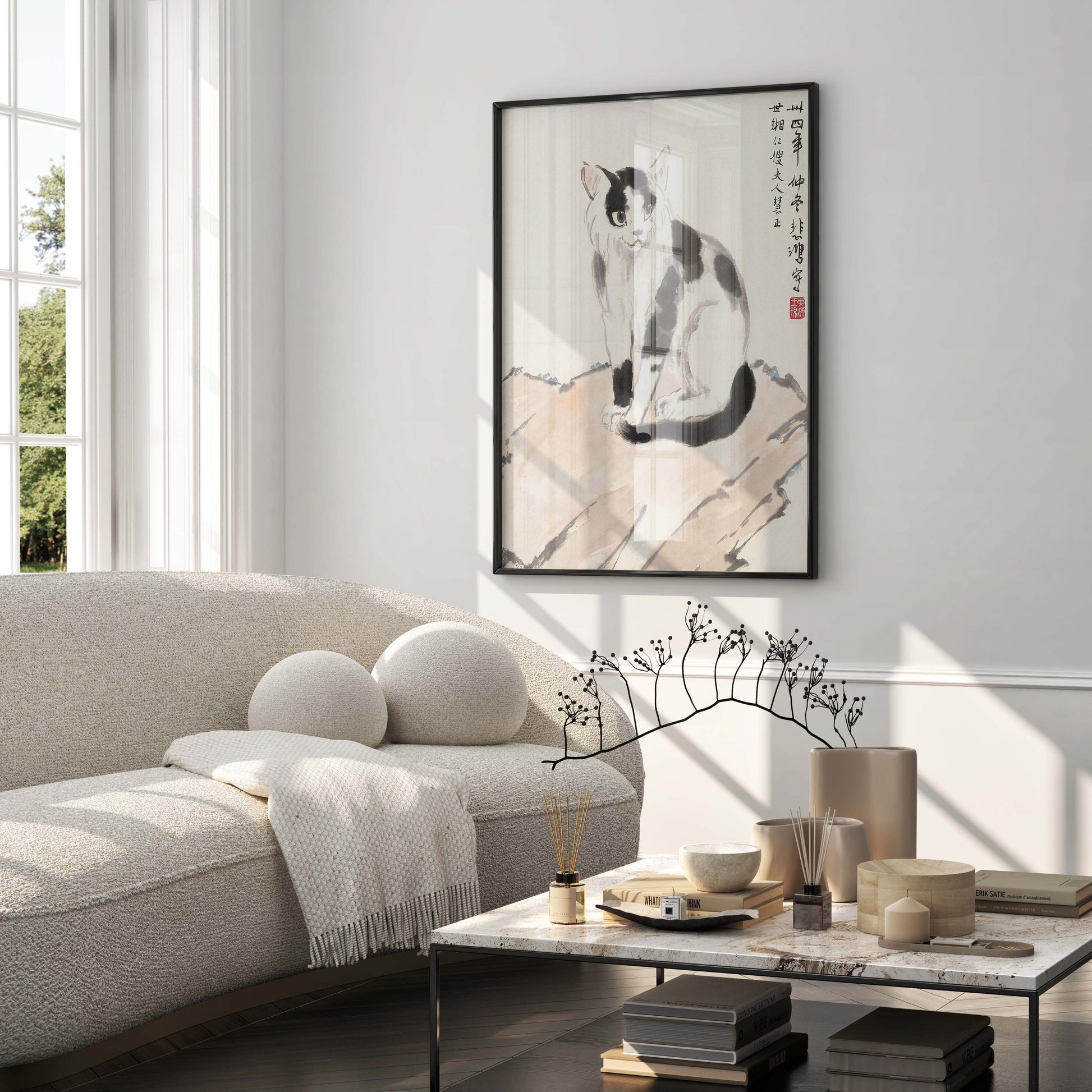 A framed fine art print of Xu Beihong's cat painting displayed in a modern, minimalist living room, showcasing how the wall art enhances home decor.